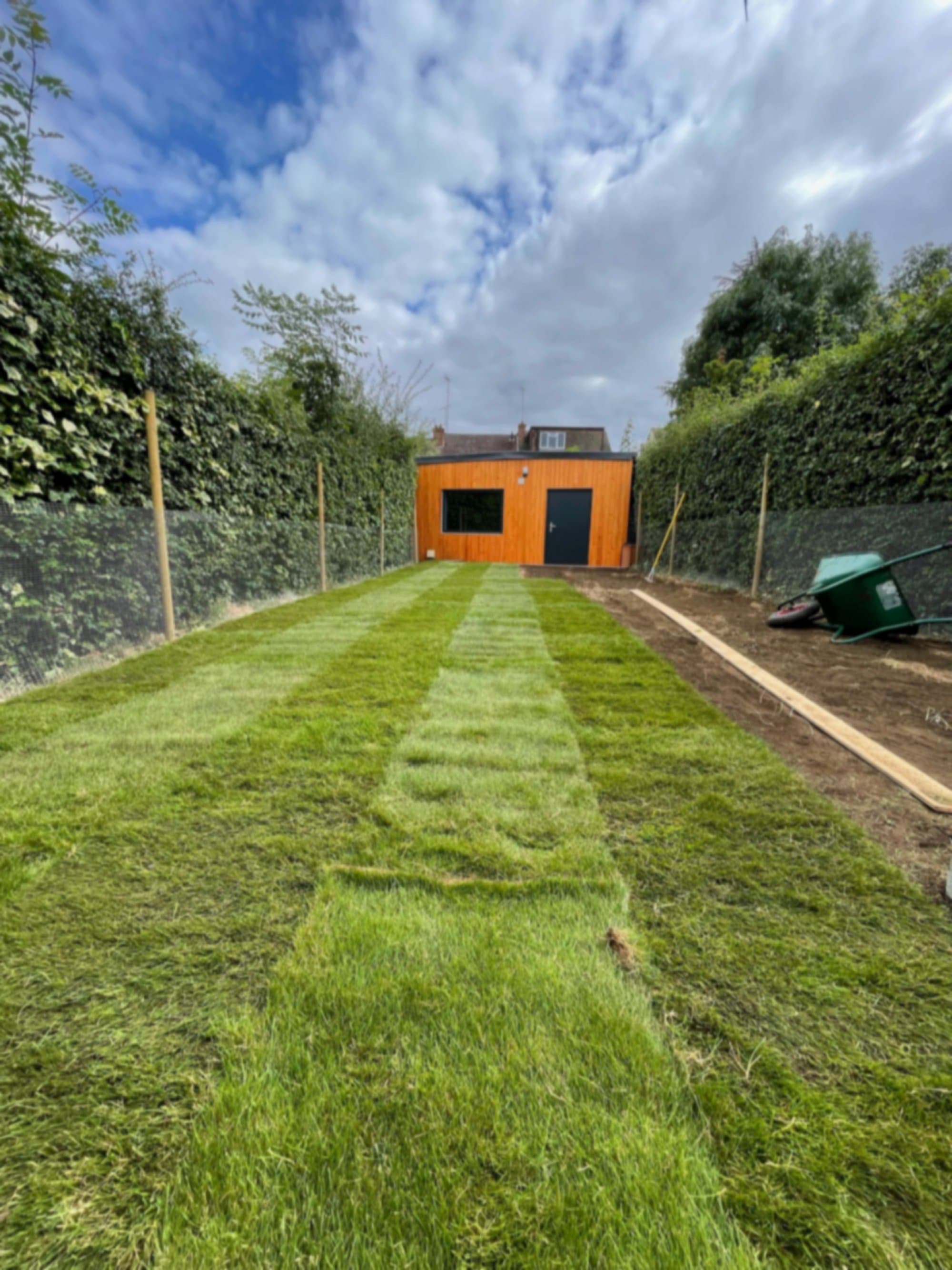 Alternate angle of the fresh turf running down towards the garden studio
