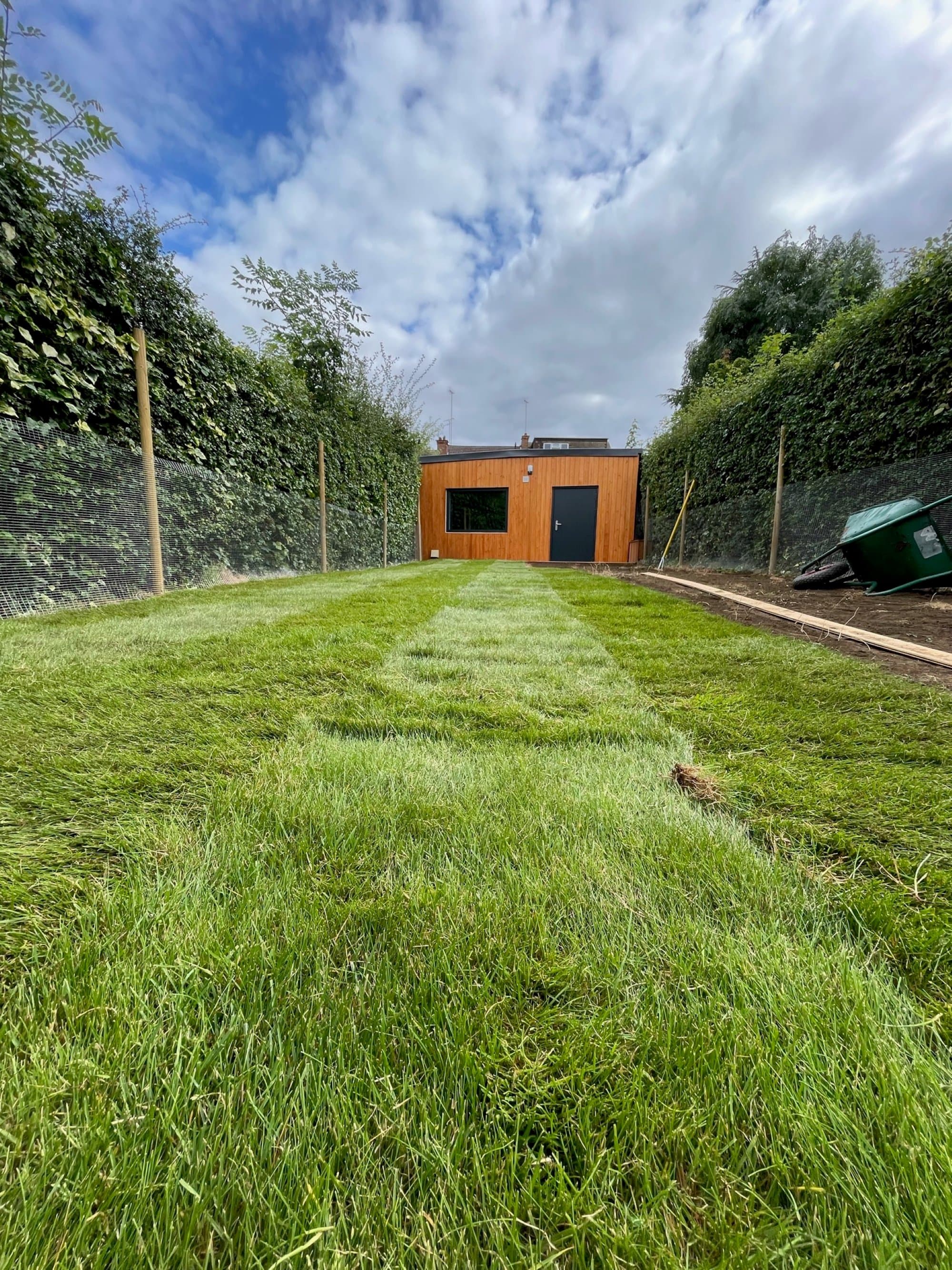 Freshly laid turf running down the full length of a Muswell Hill back garden